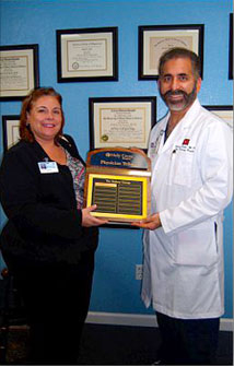 Dr. Valle recieves an award as Top Doc.